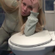 A blonde girl video-records herself having diarrhea while sitting on a toilet while commenting on her bodily functions. No visible poop action. Over 5 minutes.